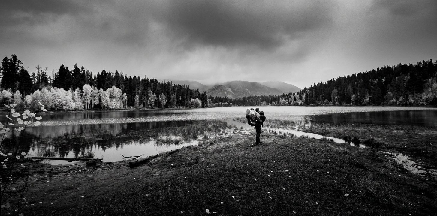 A high-contrast black-and-white landscape with dramatic clouds and crisp shadow geometry.